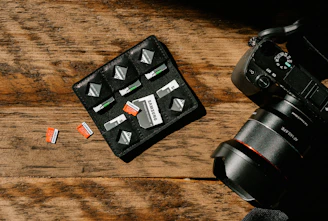 A collection of colorful memory cards and camera accessories neatly arranged on a wooden table.