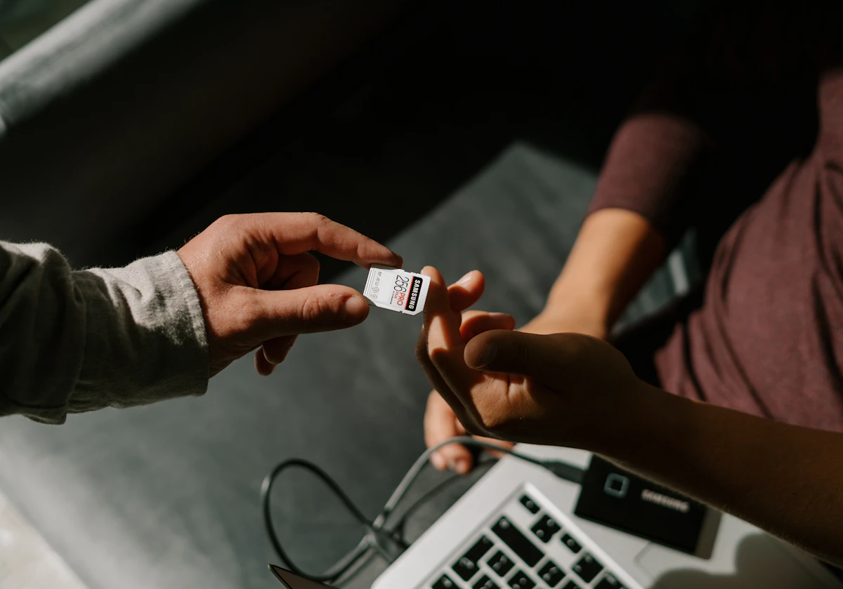 Person holding white and black card