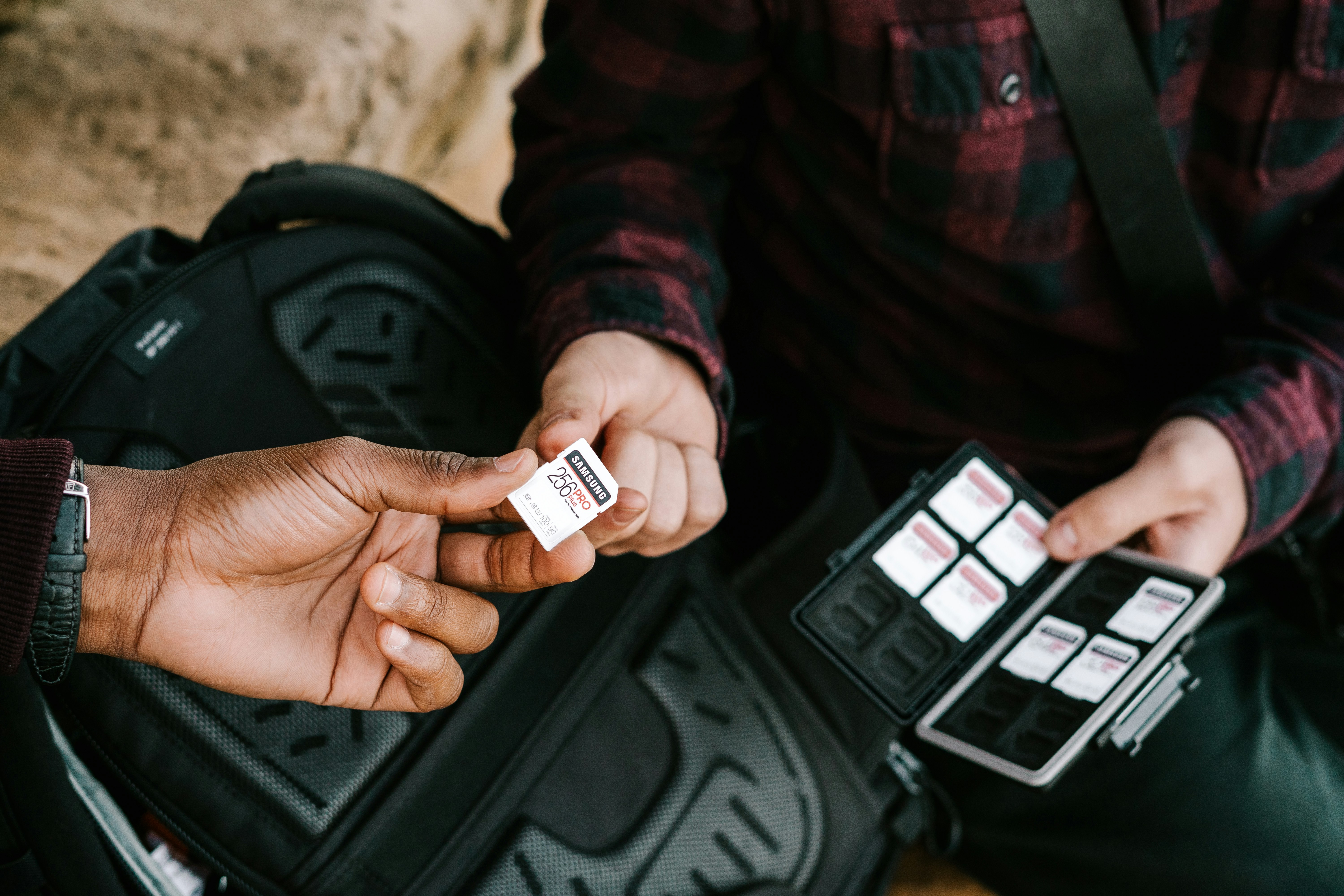 Person holding white and black plastic bottle