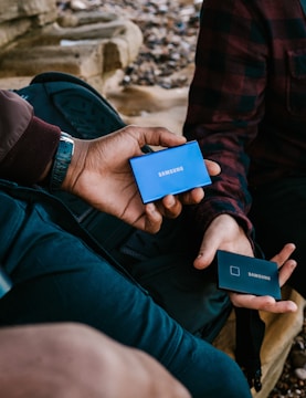 person holding blue and white card