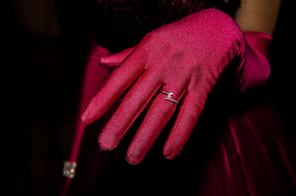 person wearing silver ring and red long sleeve shirt