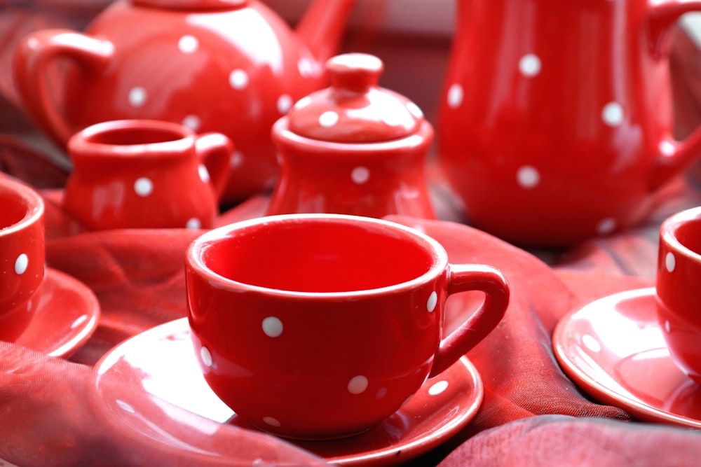 red and white polka dot ceramic teacup on saucer