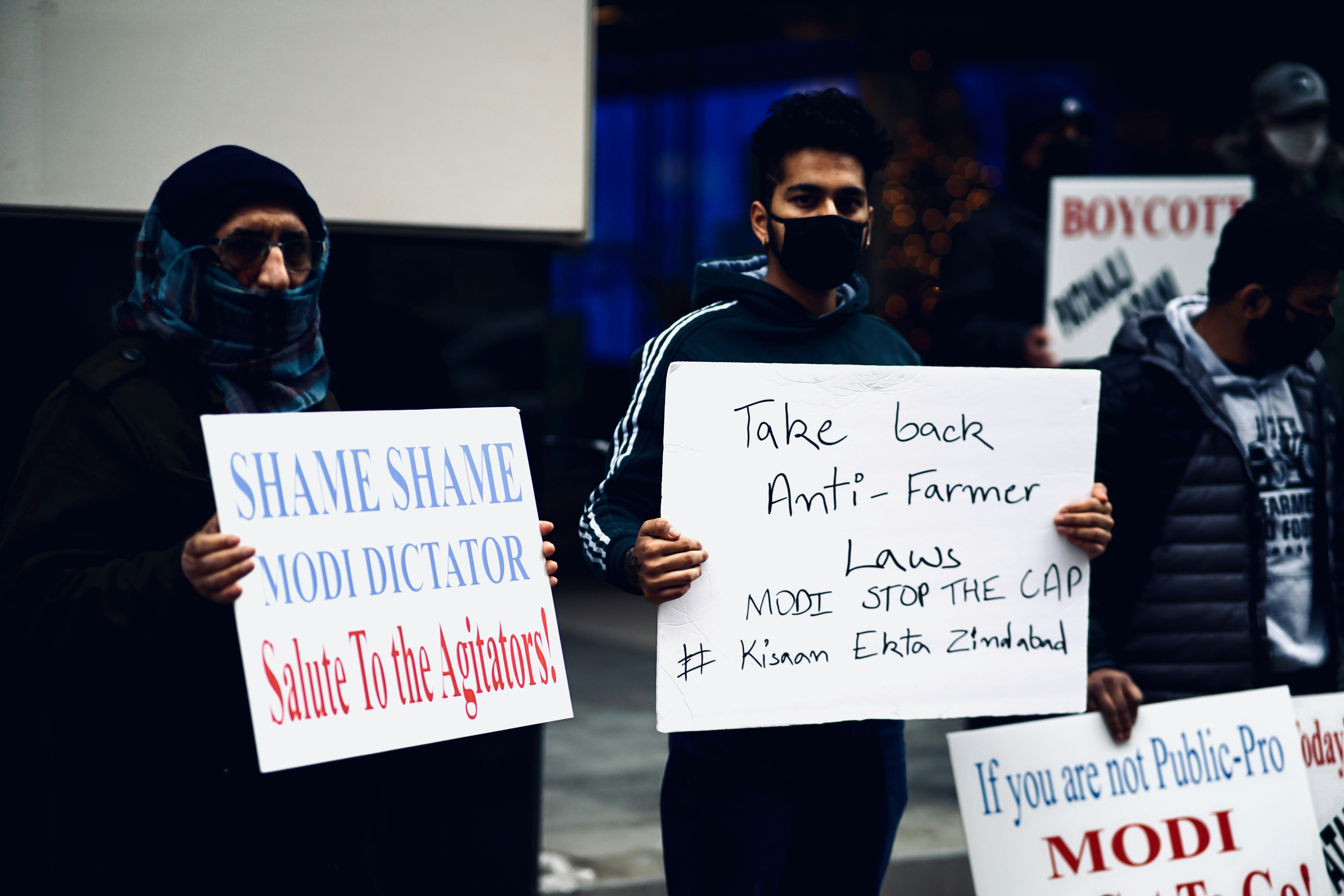 man in black jacket holding white printer paper