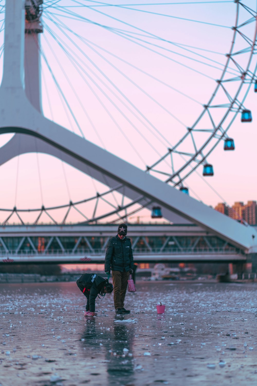 man in black jacket standing on bridge during daytime