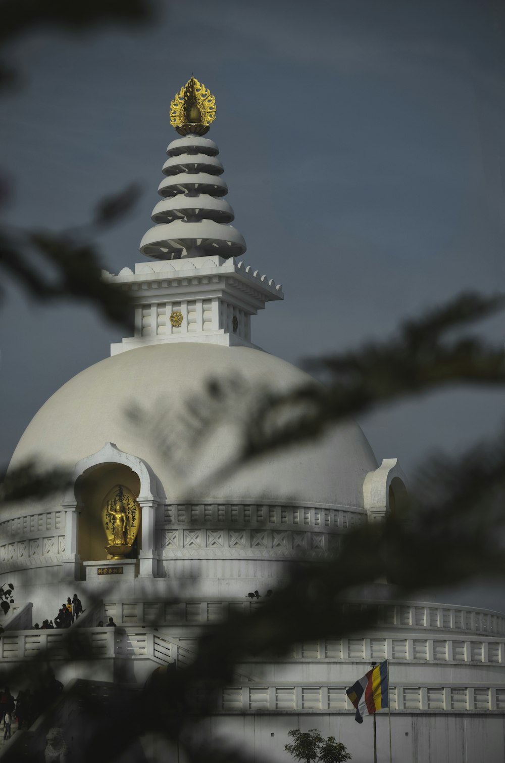 white and gold temple under white clouds during daytime