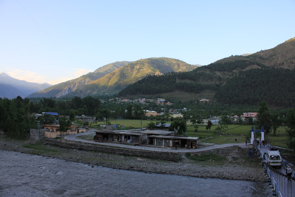 green mountain beside body of water during daytime