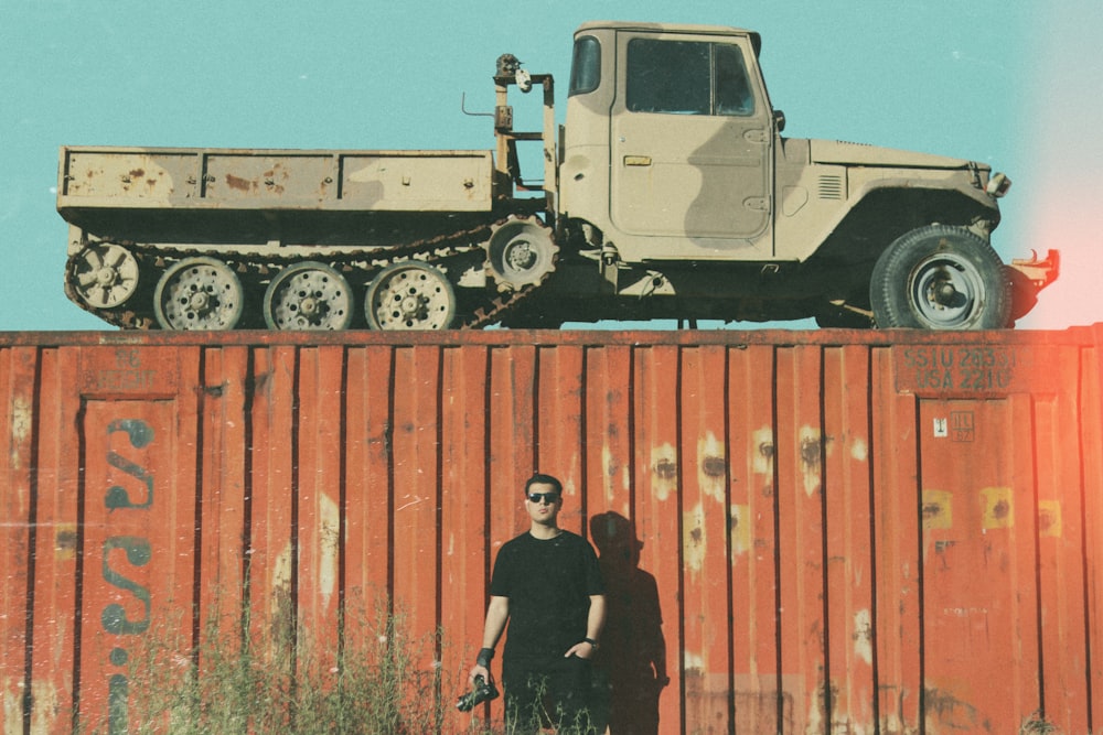 2 men standing beside truck during daytime