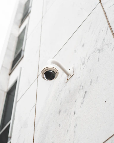 A technician installing security cameras in a modern building.