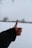 A happy customer giving a thumbs up in a snowy landscape.