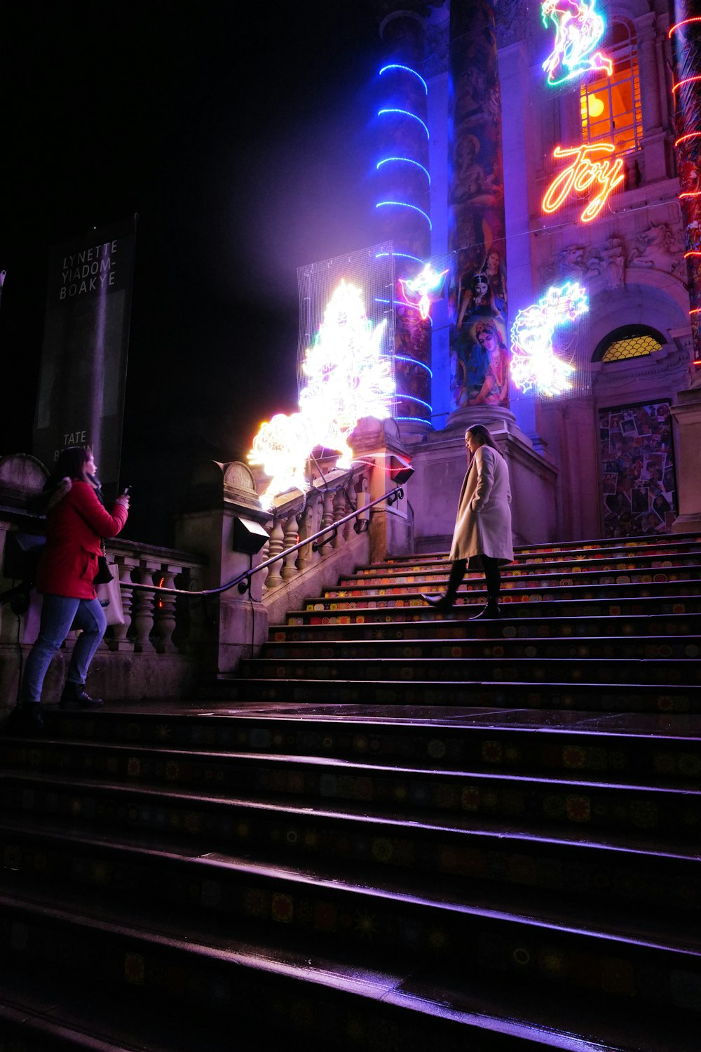 people walking on stairs during nighttime