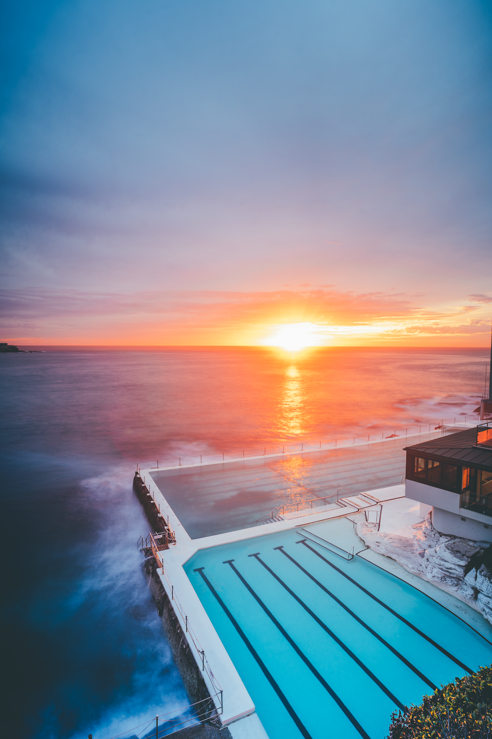 white boat on sea during sunset