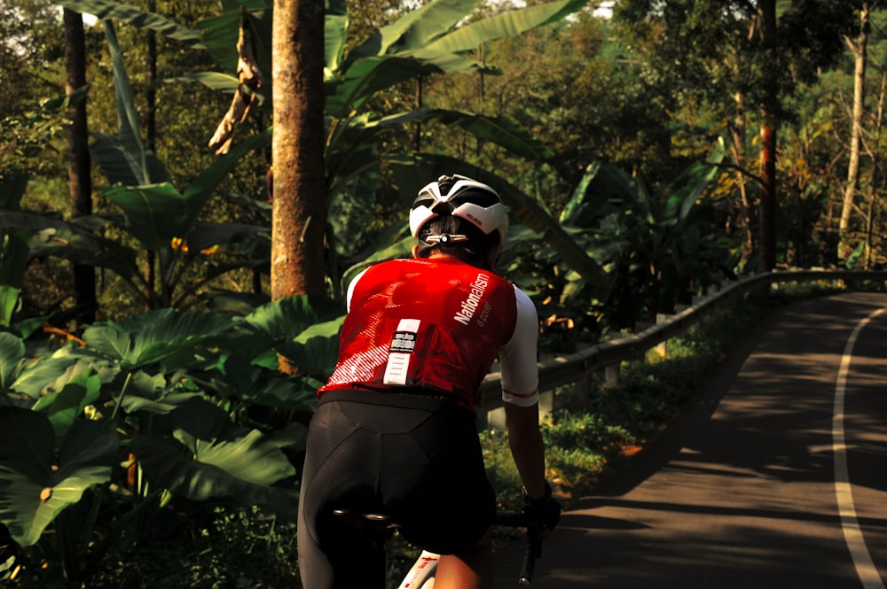 man in red and white long sleeve shirt and black pants wearing white helmet running on on on on on