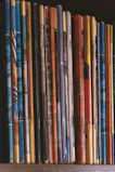 Stacked bundles of educational workbooks and worksheets with vibrant covers