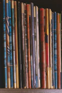 Stacked bundles of educational workbooks and worksheets with vibrant covers