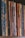 A row of vertically arranged magazines or booklets with varying colorful covers and visible spines lined up side by side. The collection exhibits a mixture of patterns and designs, with some covers worn and slightly bent, indicating frequent handling.