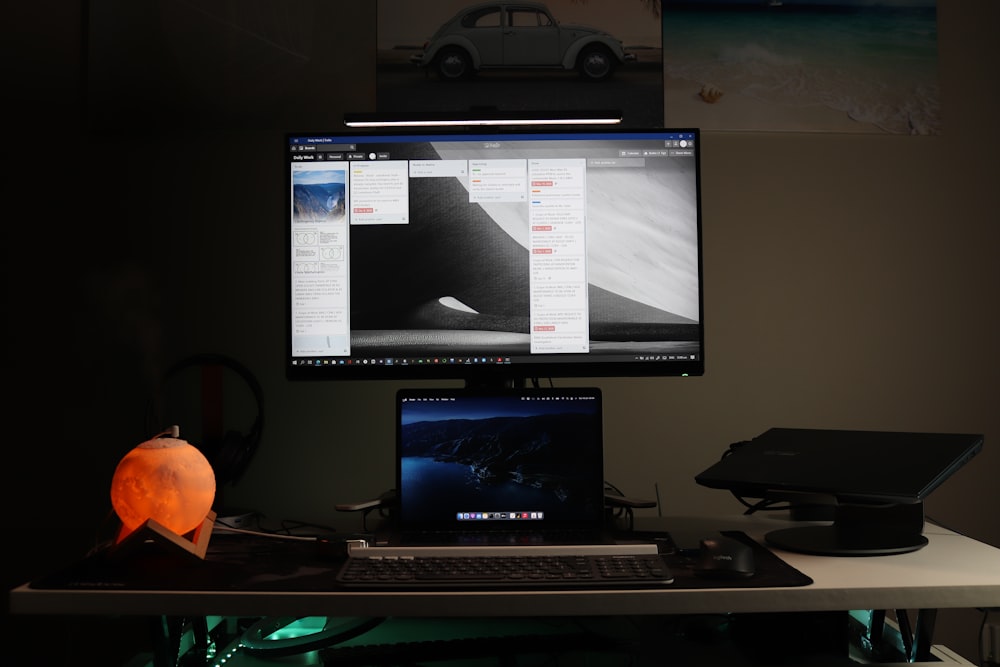 black flat screen computer monitor turned on beside black computer keyboard