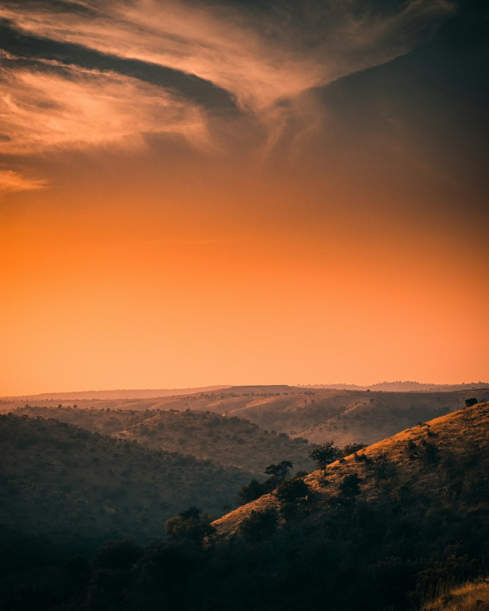 green mountains under white clouds during daytime