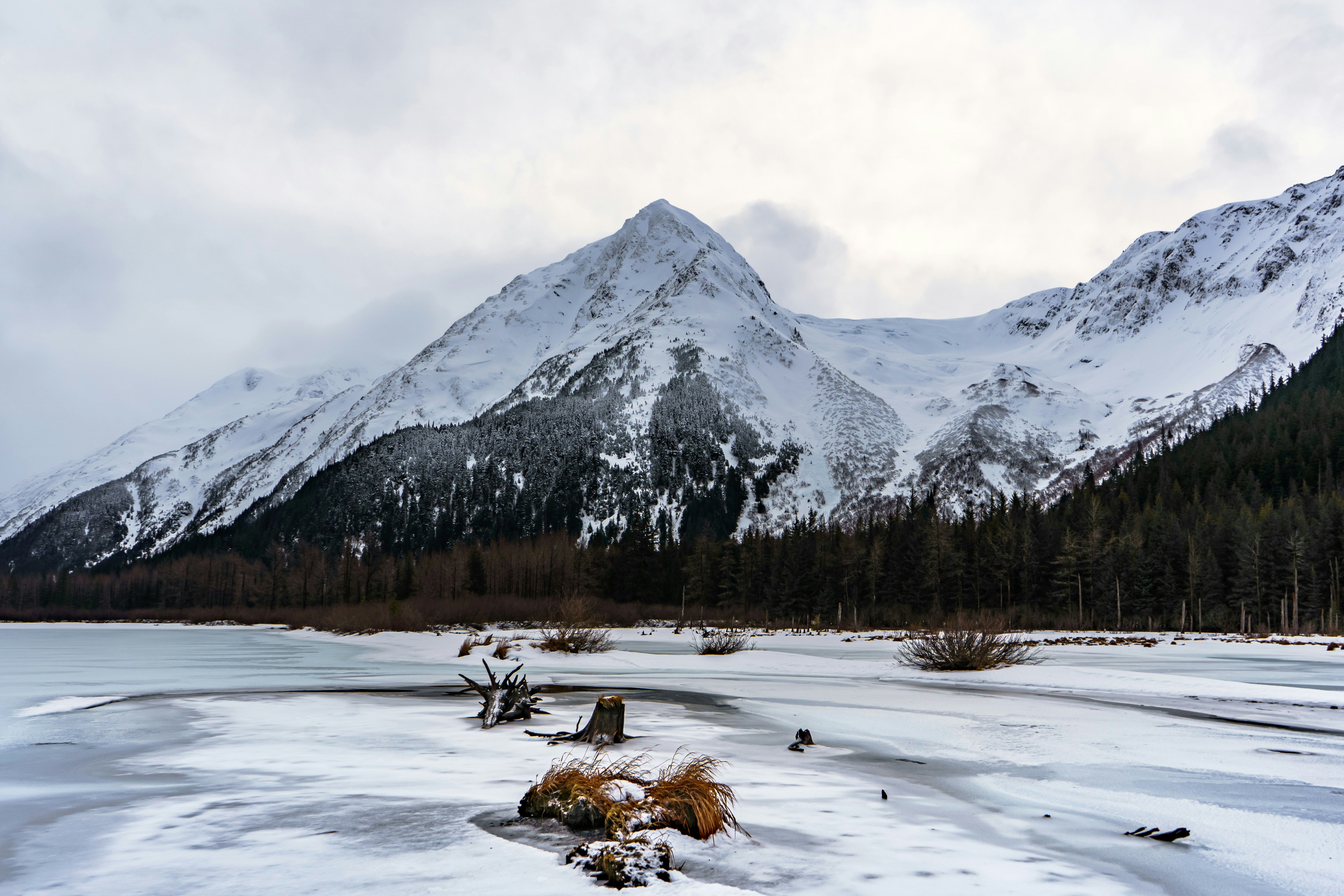 Snow covered moutnain behind a frozen lake