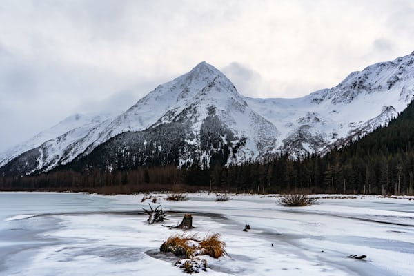 Snow covered moutnain behind a frozen lake