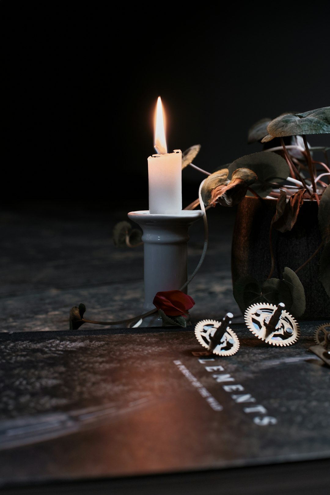 white pillar candle on brown wooden table