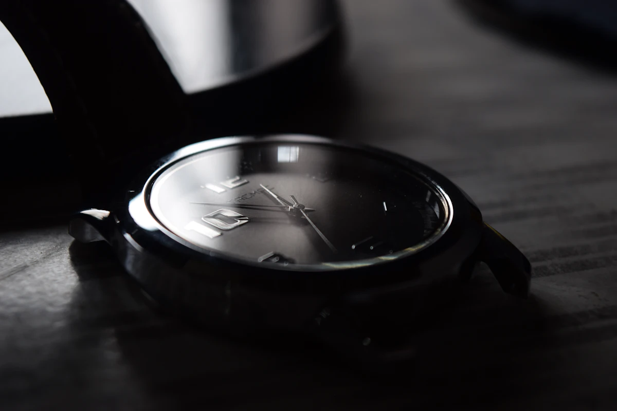 A black and silver watch in a studio product photograph