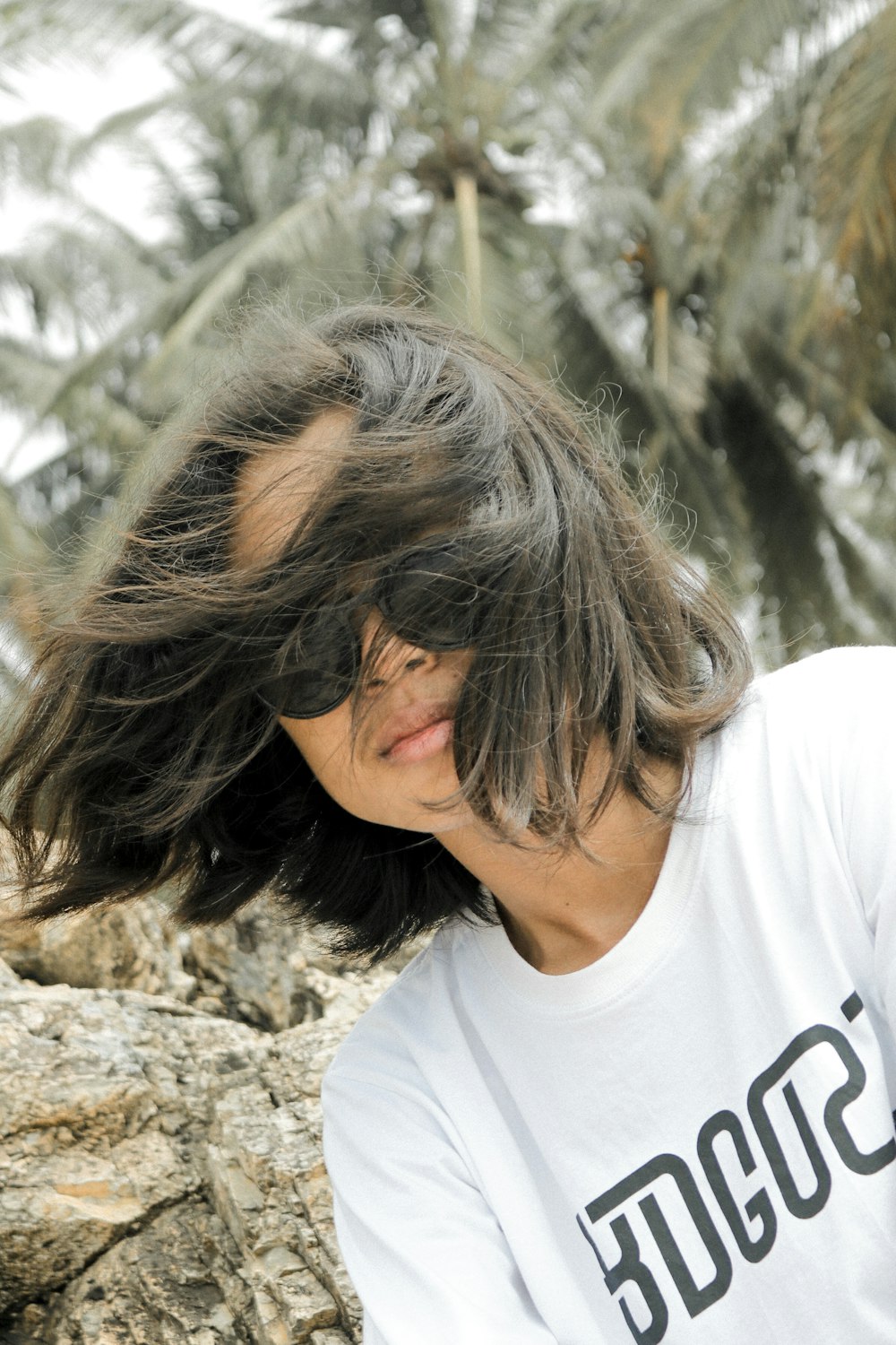 woman in white crew neck t-shirt wearing brown sunglasses