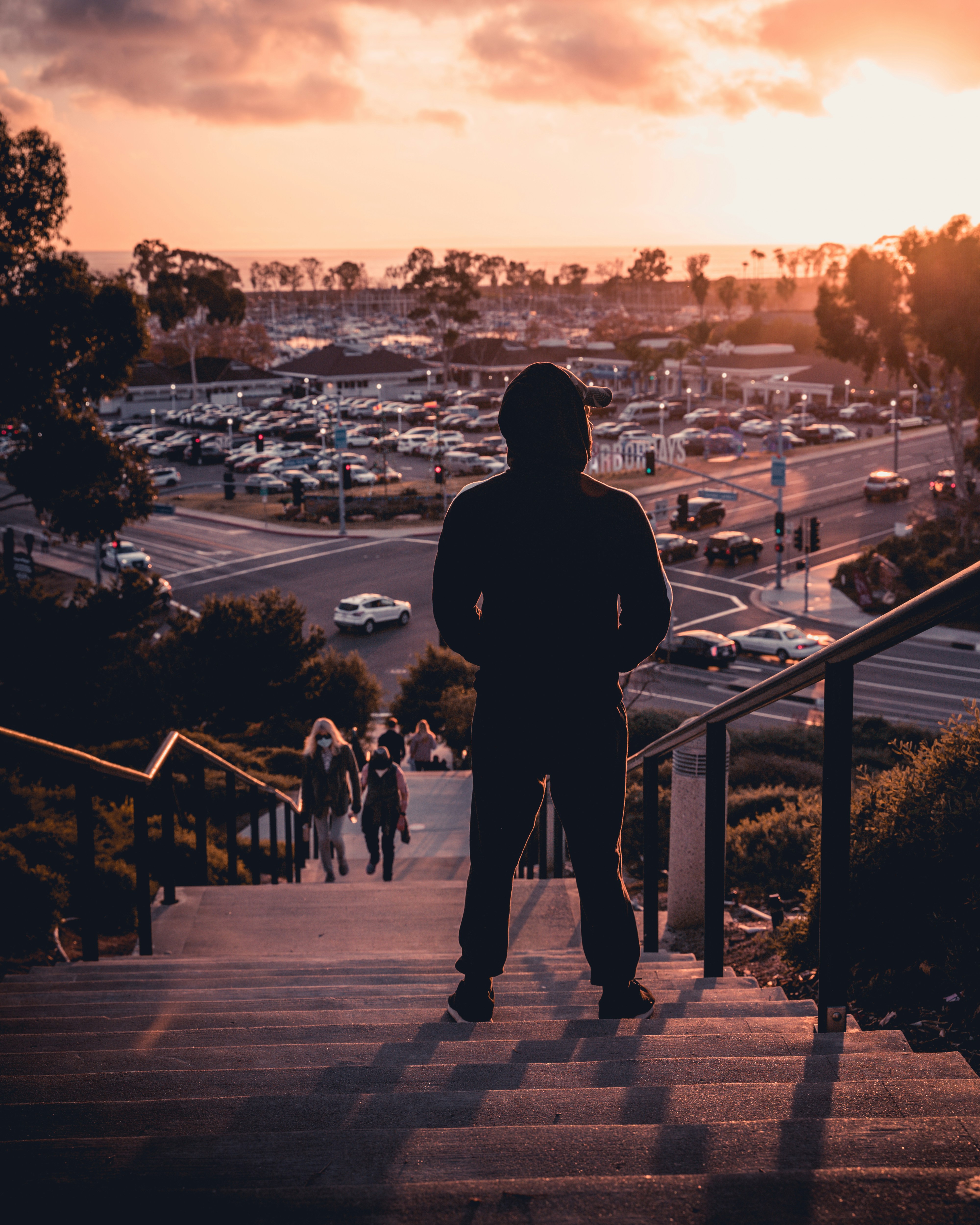 silhouette of a man watching the sunset on stairs