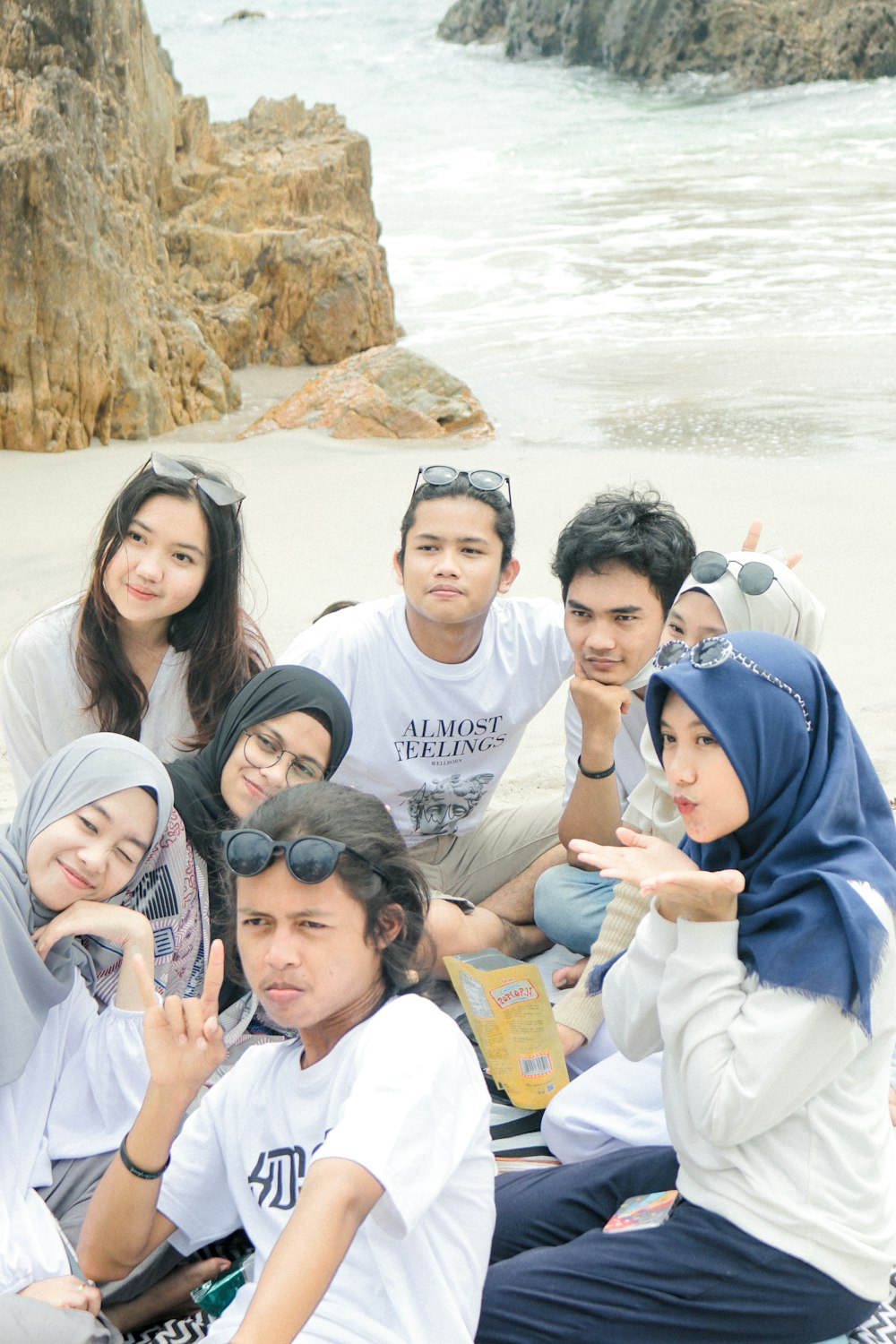 group of people taking photo near body of water during daytime