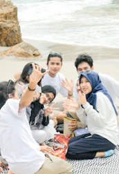A group of friends sharing their skip-a-snack challenge on social media with bright smiles.