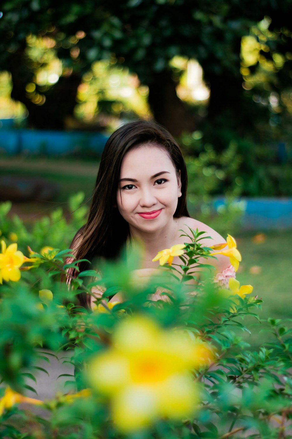 woman in yellow floral dress smiling