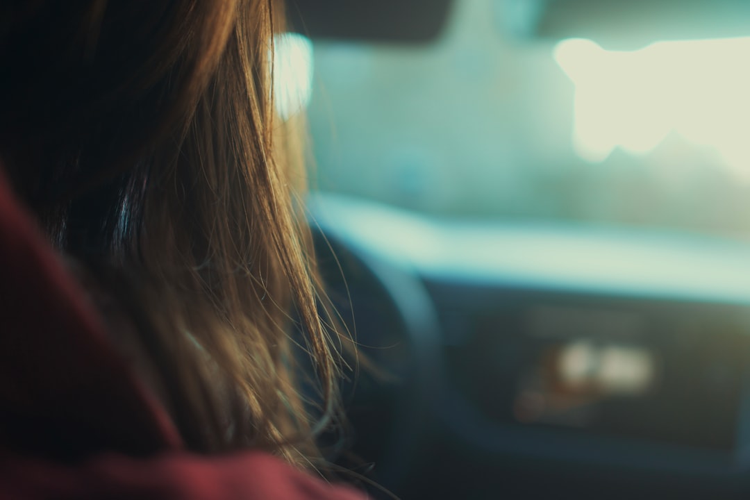 woman in red shirt sitting inside car