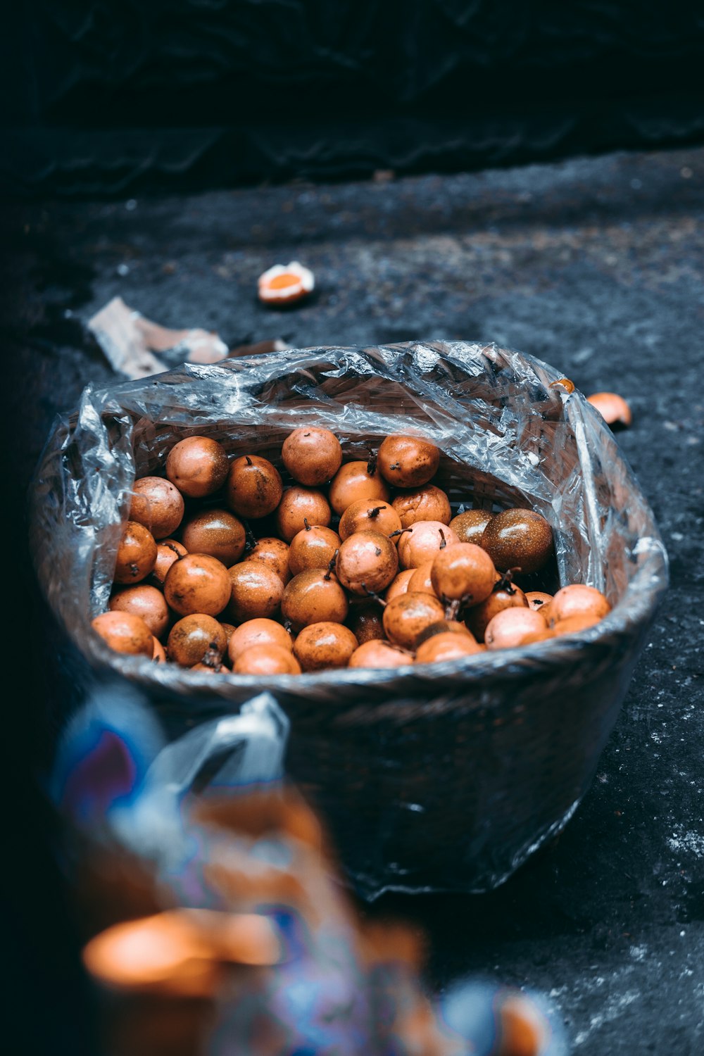 brown round fruits in black bucket