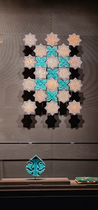 Decorative ceramic tiles with vibrant geometric designs displayed on a wall.