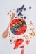 red strawberries and blue berries on white ceramic bowl