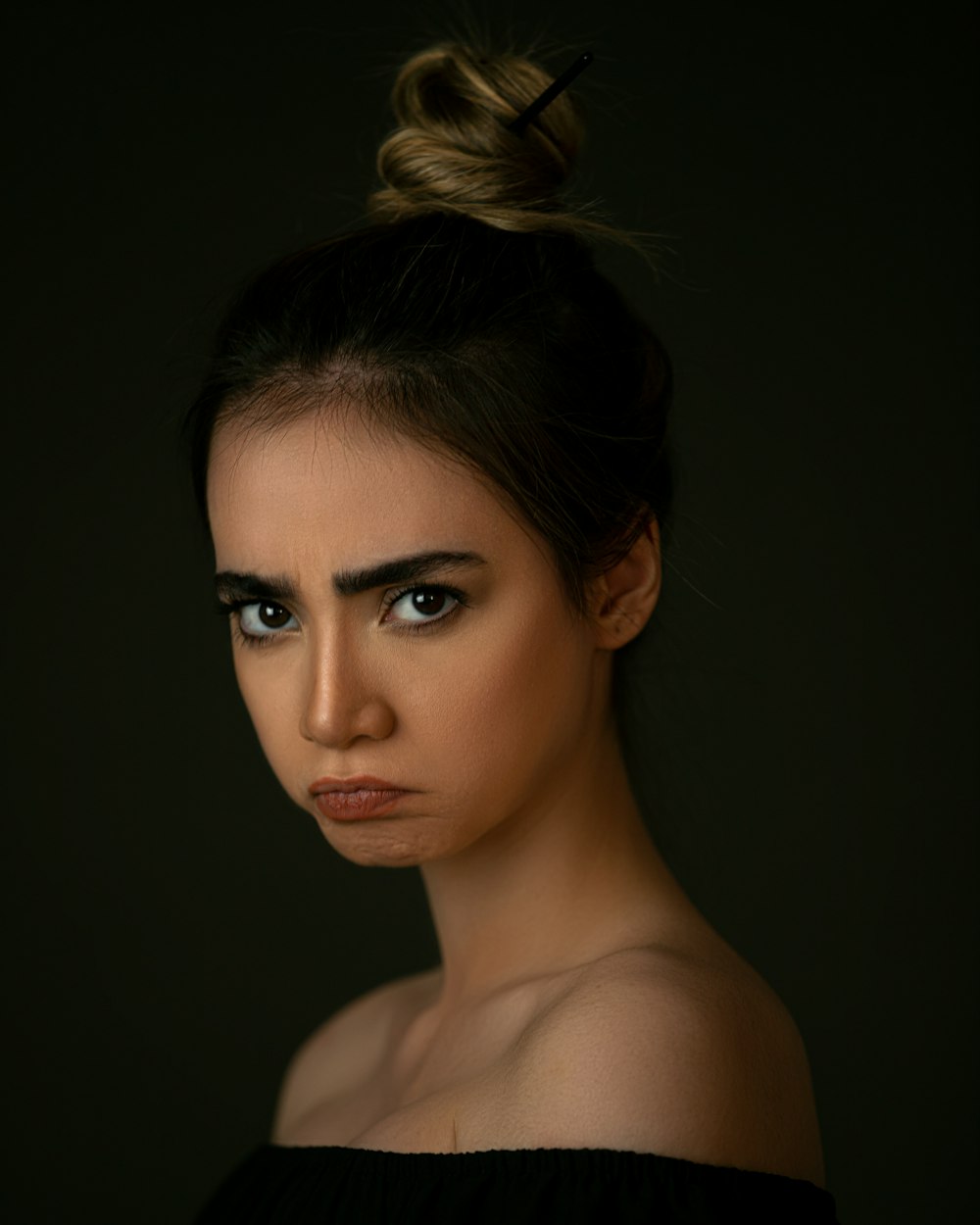 woman with brown hair and black eyes