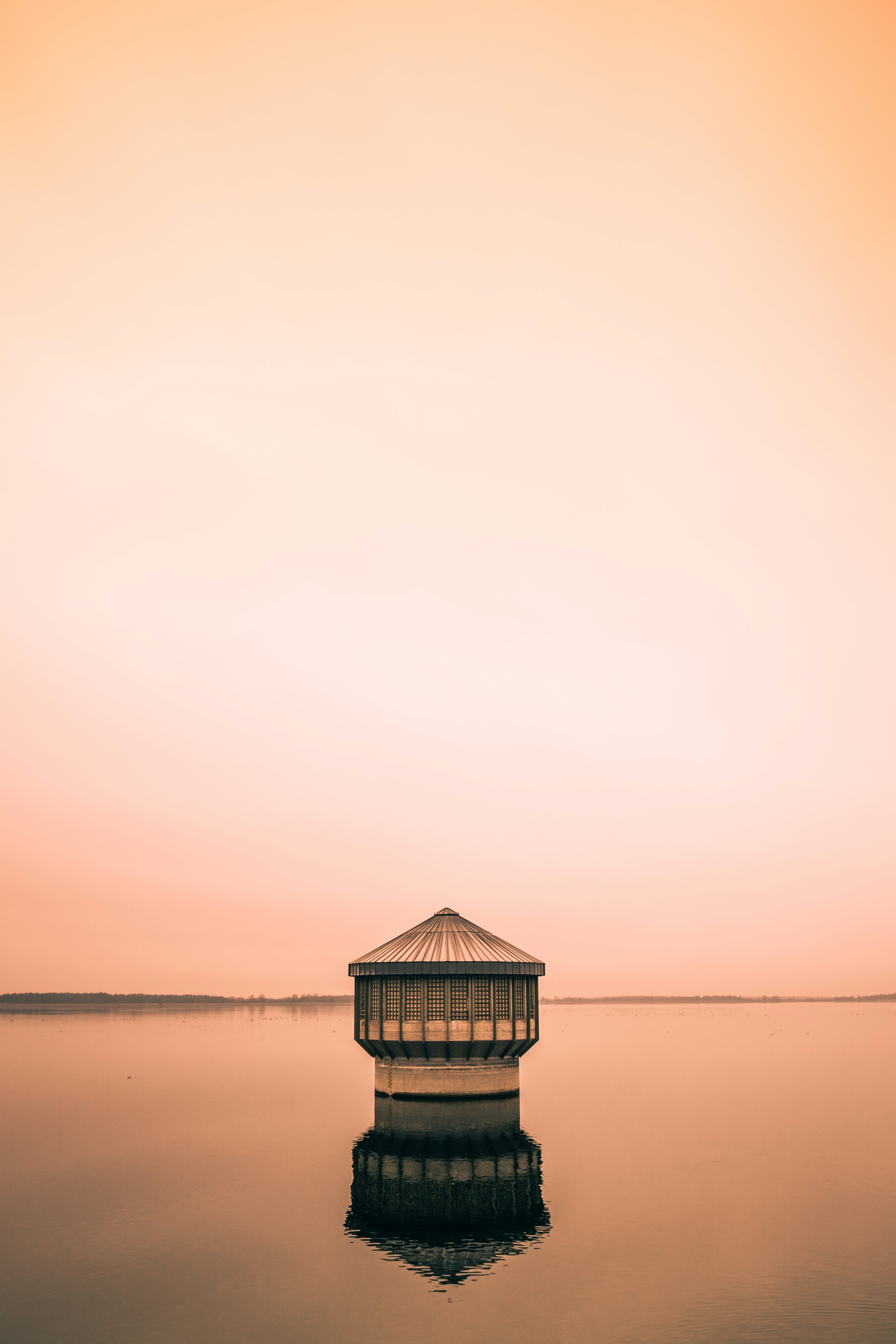 brown wooden house on beach during daytime