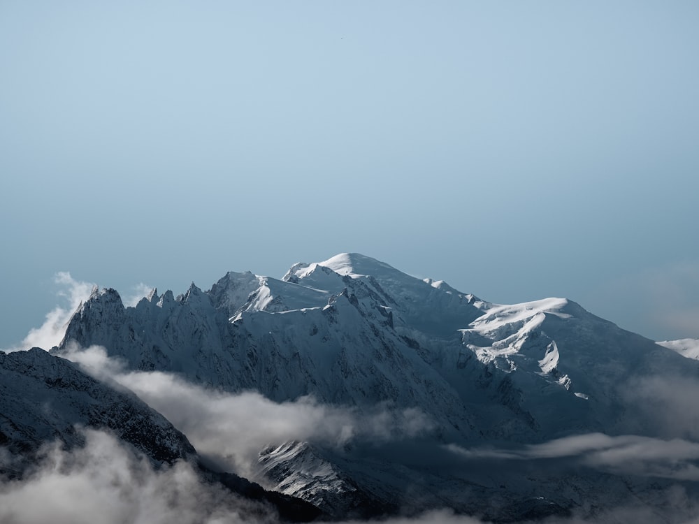 snow covered mountain under white sky during daytime