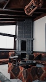 black fireplace near brown couch