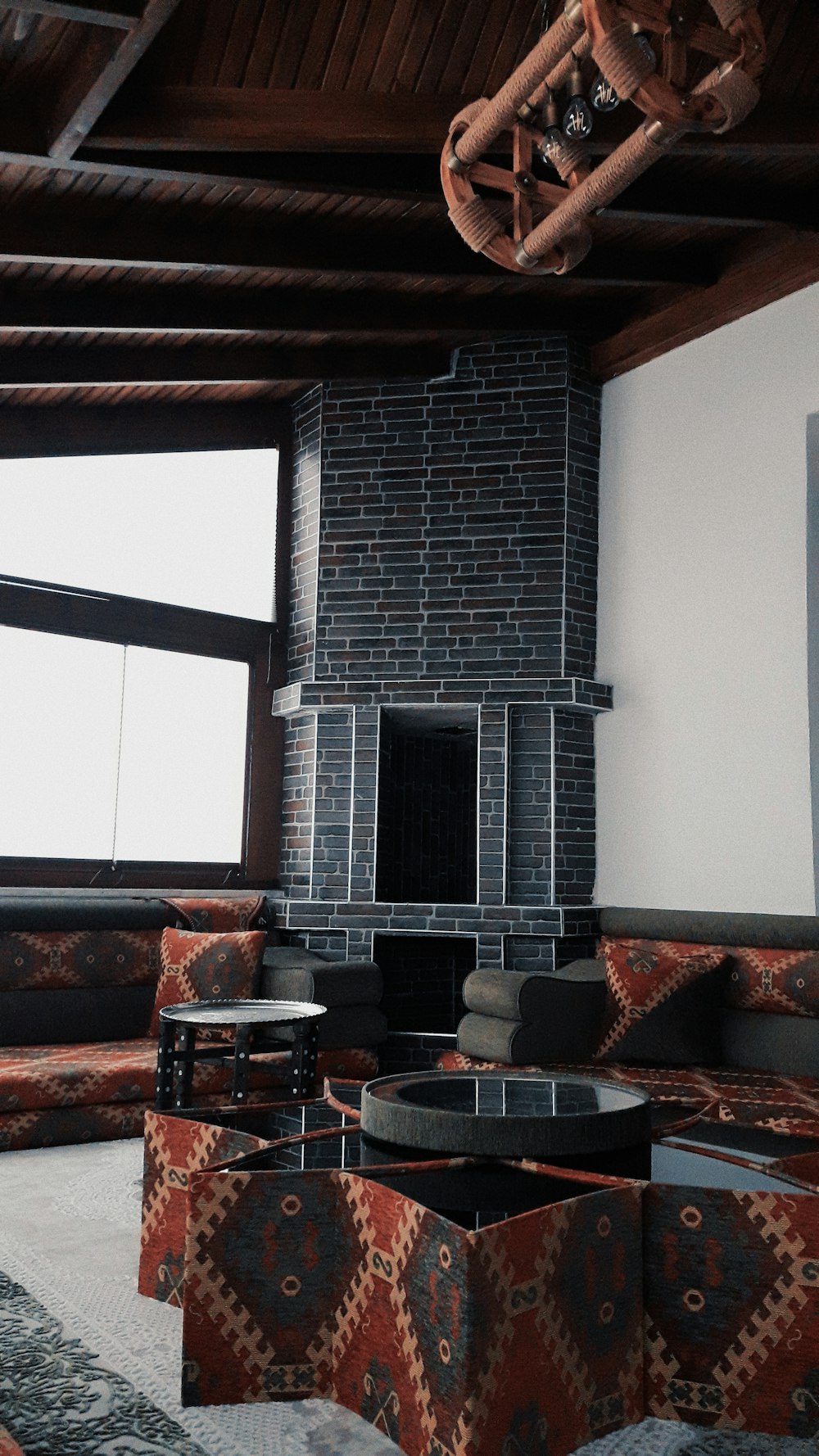 black fireplace near brown couch