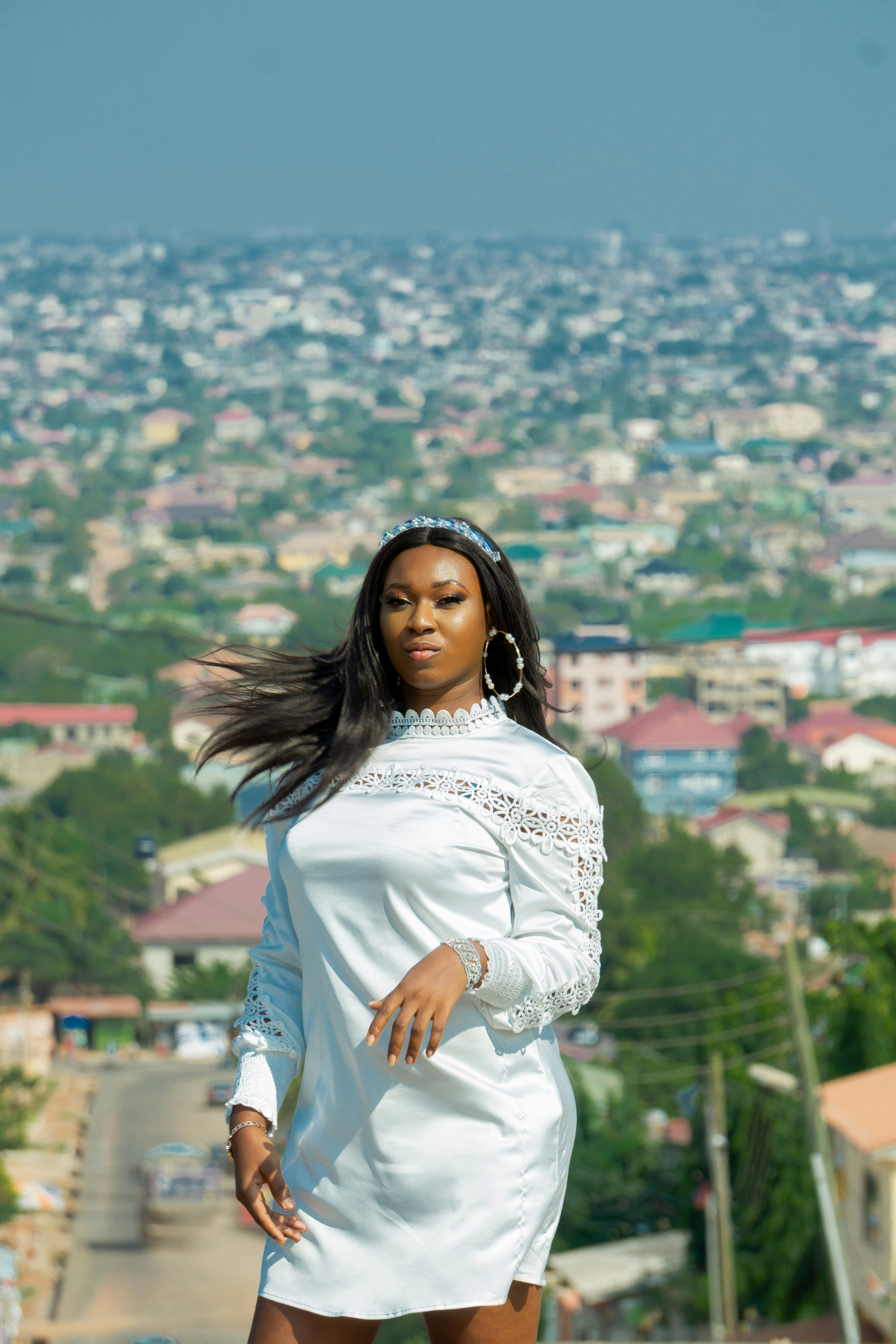 woman in white long sleeve shirt standing on top of building during daytime