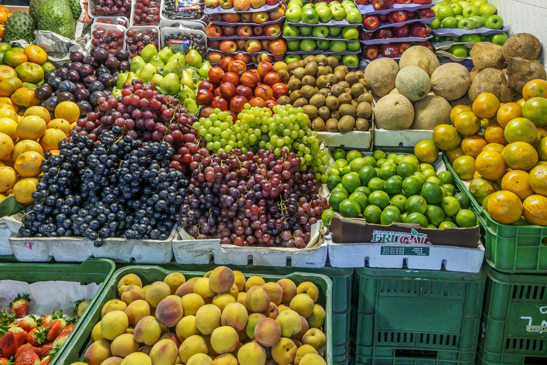 green and red apples on blue plastic crate