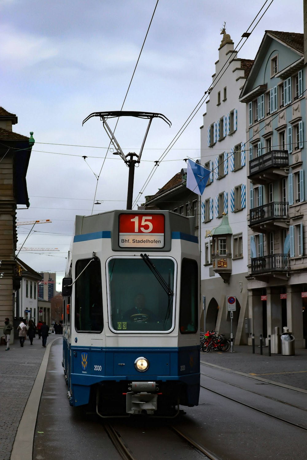 blue and white tram on road during daytime