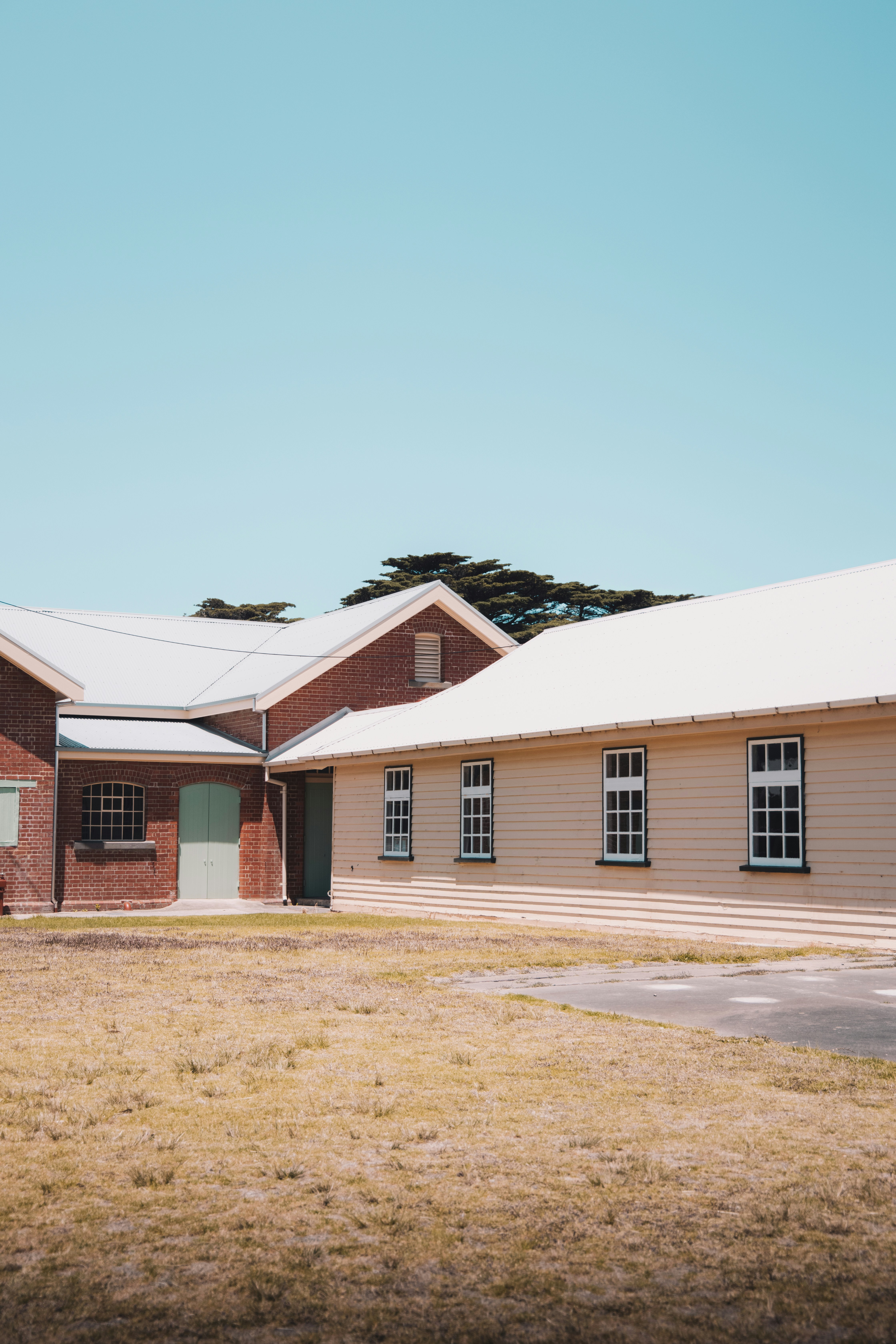 white and brown concrete house under blue sky during daytime