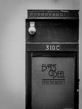 A sleek black and brown background featuring subtle scientific diagrams and technical blueprints with the address 70 Hall Street, Soham, Ely, England, CB7 5BW elegantly overlaid.