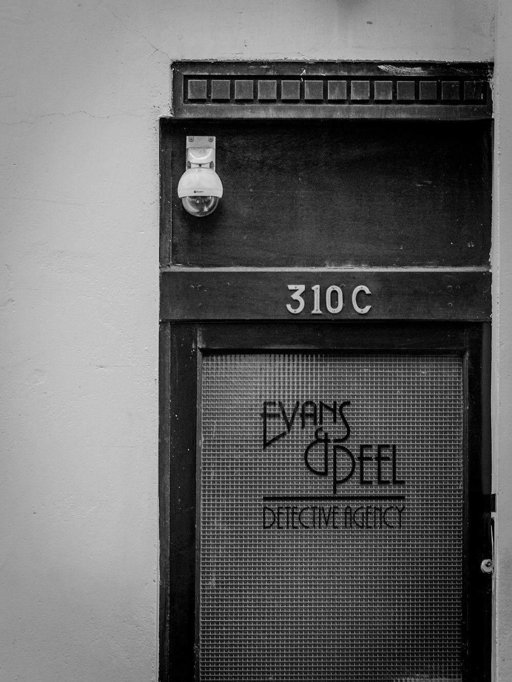 black wooden door with white wall