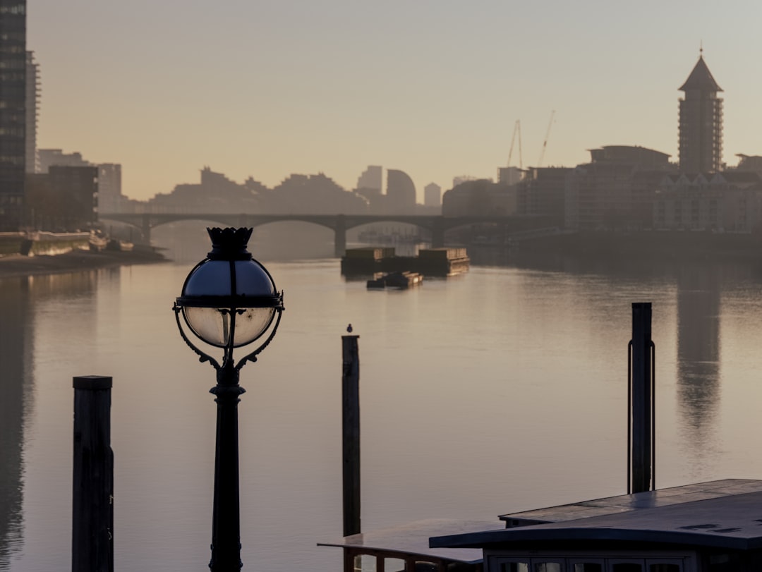 black post lamp near body of water during daytime