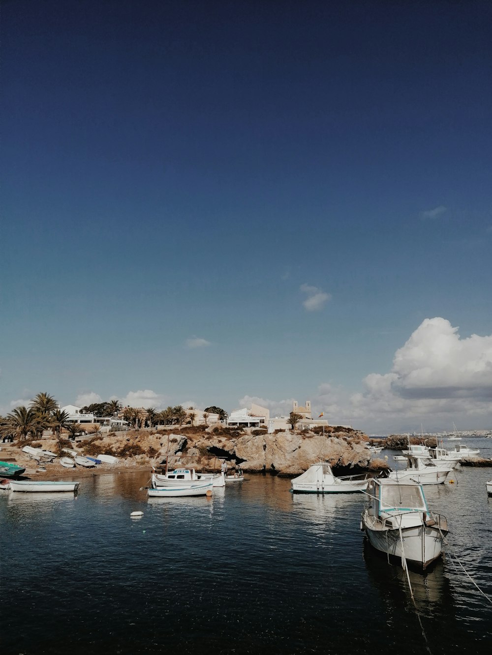 white boat on body of water during daytime