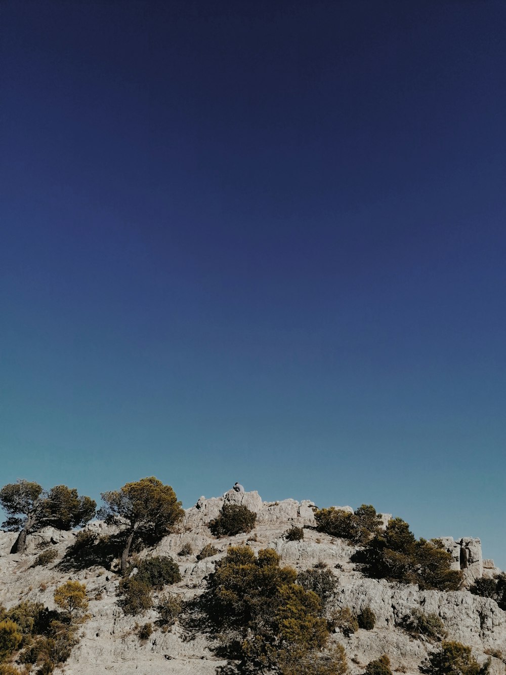 brown and white rock formation under blue sky during daytime