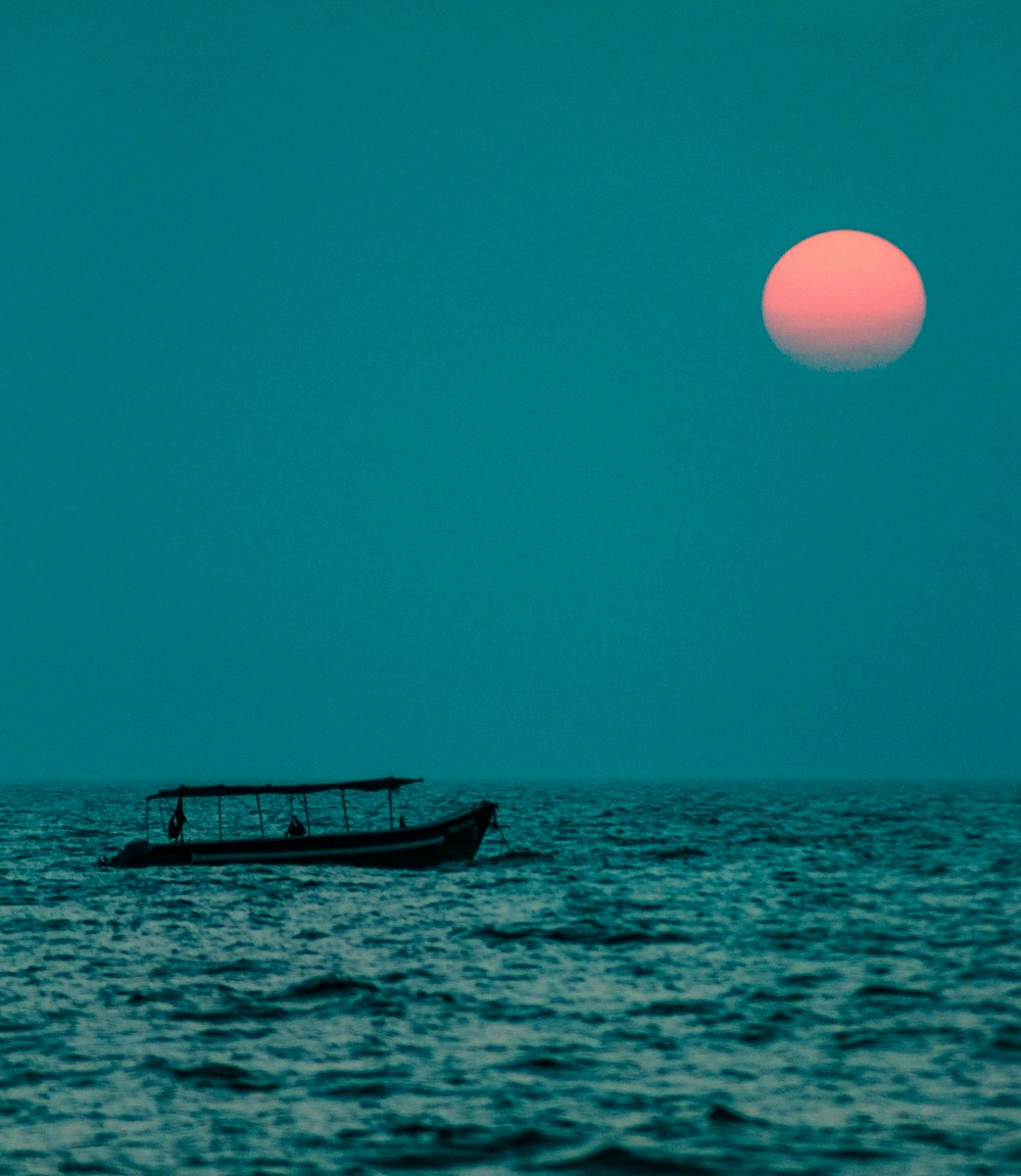 white and black boat on sea during daytime