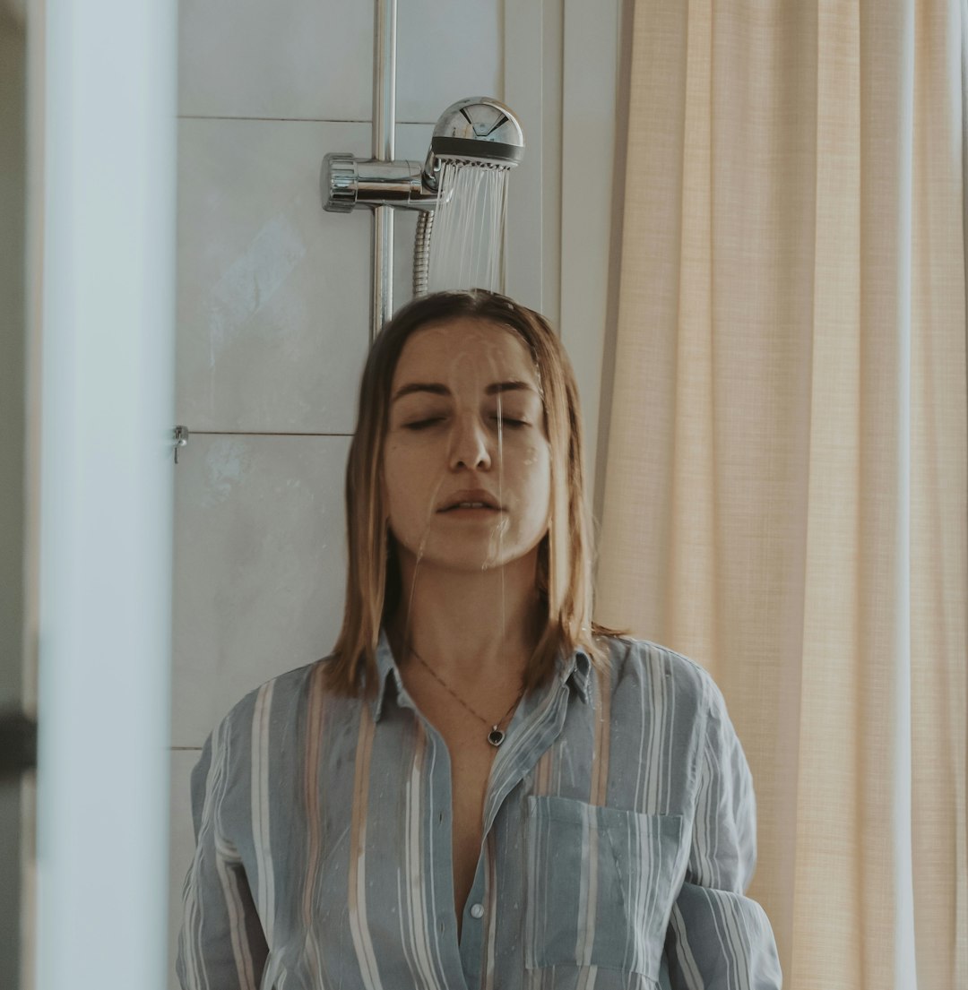 woman in blue and white stripe button up shirt